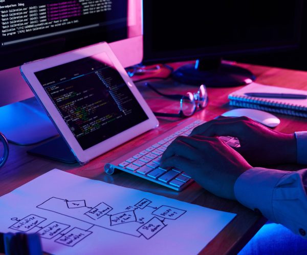 Close-up image of programmer working at his desk in office